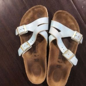 Birkenstocks in distressed light blue